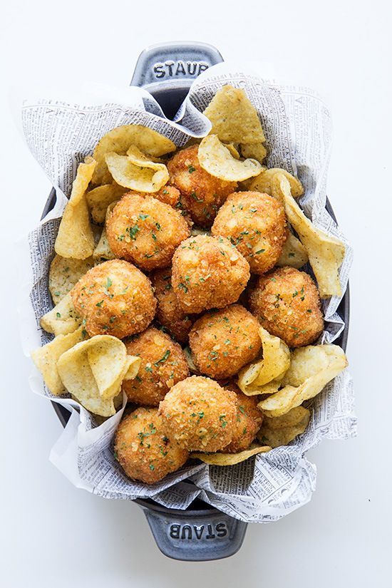 Clam fritters served in a cone of newspaper